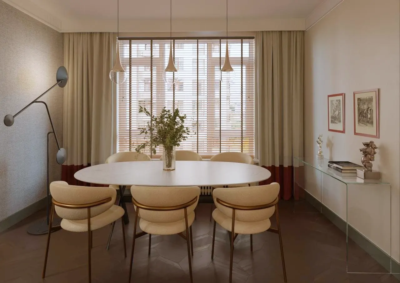 Oval dining table, upholstered chairs and glass pendant lights