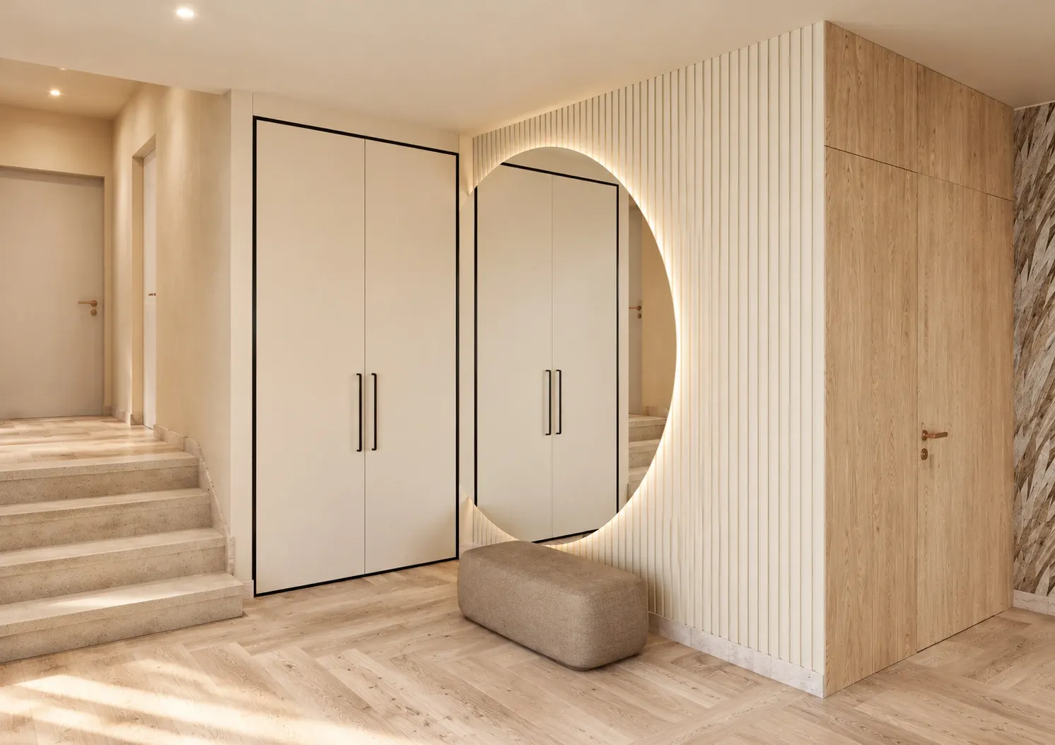 Entrance with an illuminated round mirror, vertical wall detailing and timber cabinetry